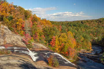Toxaway Falls fall colors Horizontal Photo on us64 in NC Blueridge Mt. Photograph with blue sky white clouds red orange, green, yellow trees - obrazy, fototapety, plakaty