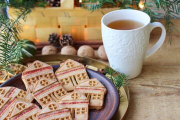 Christmas eve. Cookies in shape of houses and cup of tea