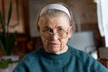 Close-up portrait of an aged woman. Emotion of surprise on her face.