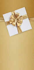 Mothers day gift card, white box wrapped with golden ribbon bow isolated on beige glittering...