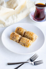 Walnuts baklava on a white plate. Turkish cuisine flavor baklava. Vertical view.