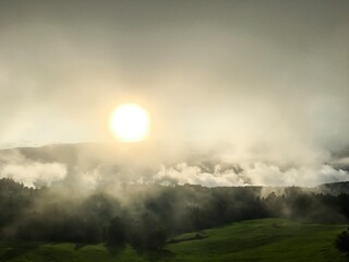 Scenic view of mountains against cloudy sky, fog and sun light