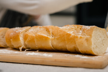 A little girl cook cooks bread dough at home in the kitchen. Home cooking.
