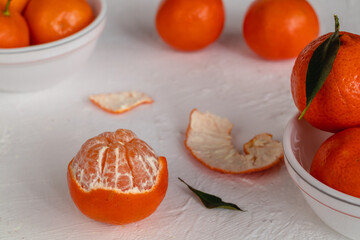 Peeled mandarin oranges close up on a white background.