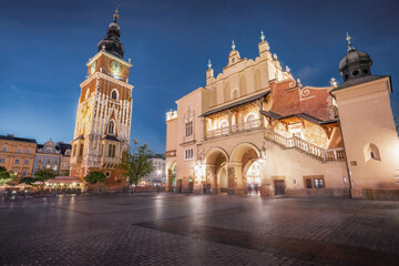 Naklejka na ściany i meble Town Hall Tower and Cloth Hall at Main Market Square at night - Krakow, Poland