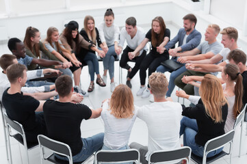 Obraz premium group of young like-minded people holding each other's hands