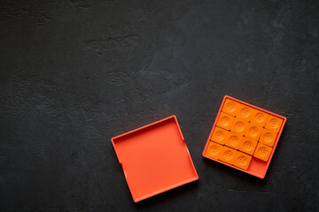 Pocket sliding puzzle with fifteen chips on a dark background