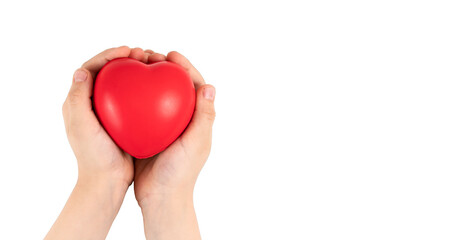 Childâ€™s hands holding red heart on white background.