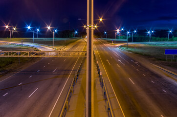 Fototapeta na wymiar night empty road with illuminated lanterns