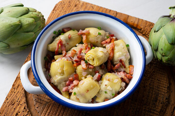 Artichokes in oil with bacon. Traditional Spanish tapa.