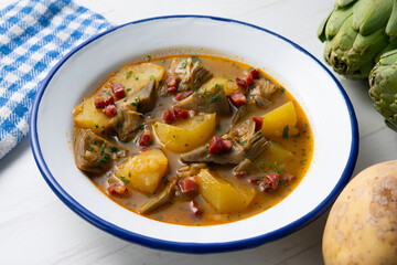 Soup with artichokes, ham and potatoes. Traditional Spanish tapa.