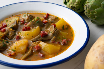 Soup with artichokes, ham and potatoes. Traditional Spanish tapa.