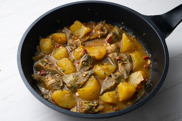 Soup with artichokes, ham and potatoes. Traditional Spanish tapa.