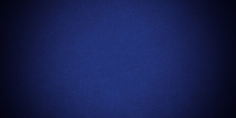 Dark blue background texture with black vignette in old vintage grunge textured border design, dark elegant teal color wall with light spotlight center