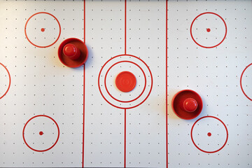 Naklejka premium An air hockey field with red round handles. Top view. Active games for two players.