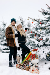 Fototapeta na wymiar a happy couple arranges the Christmas tree