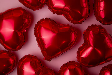 Background from red foil balloons on a pink background. Concept for Valentine's Day, March 8, Mother's Day, for bachelorette and engagement parties.