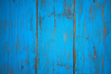 Photo of a wooden texture painted with retro blue paint. Aged wooden background with vertical stripes.
