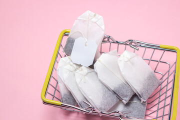 Tea bags on a pink background. A quick way to brew tea. Morning drink