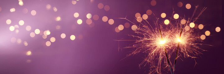 Naklejka premium Happy New Year background with glowing sparklers.