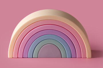 Fototapeta premium Silicone rainbow stacker puzzle, baby stacking toy building blocks, open ended Montessori nesting and sensory fidget toy teether gifts for toddlers and kids. Colorful educational first soft baby toy