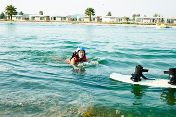 young smiling girl on wake board in water, happy lifestyle people on vacations