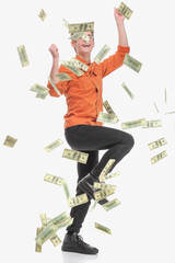 Happy young man enjoying rain of money, isolated on white