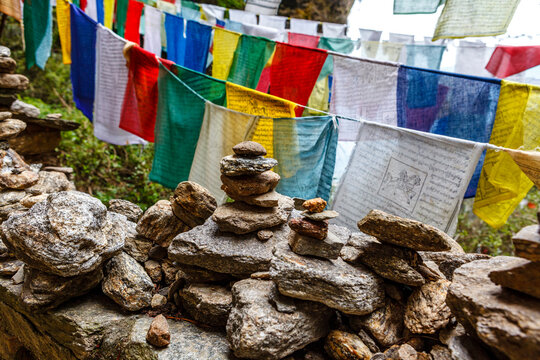 Prayer flags and rocks in the mountains around the Tiger's Nest monastery (Taktshang Goemba) in Paro, Bhutan, Asia