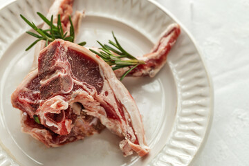 Raw lamb chops on plate