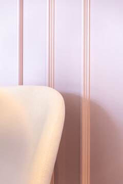 White chair placed near smooth wall with lines