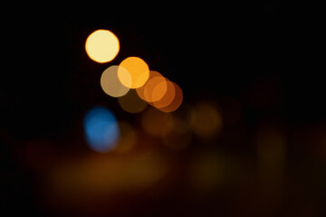 street lights in blurred focus. mix of orange, blue, yellow color