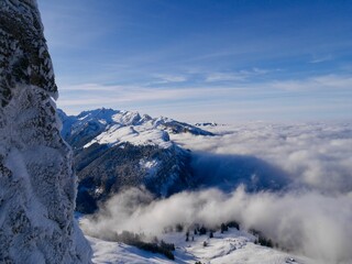 Spectacular view from Hoher Kasten cable car cabin down to foggy Alpstein mountains and Appenzell. Switzerland.