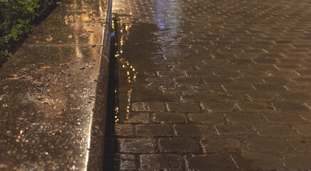 Texture of wet sidewalk after rain with illumination reflection