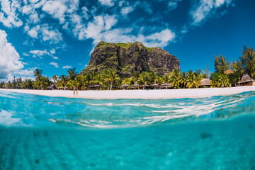 Tropical ocean with Le Morne mountain and sandy beach. Split view.