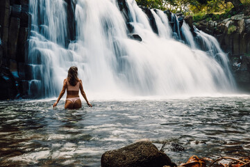 Rochester Falls and woman in bikini. Amazing cascade waterfall at Mauritius