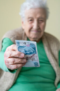 Closeup Wrinkled Hands Of Old Person Holding Money, Turkish Lira Banknotes