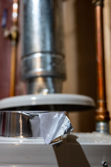 selective focus on the edge of a roll of metallic aluminum foil HVAC duct tape