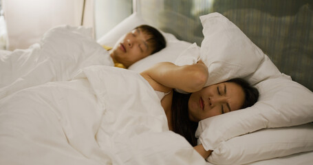 Woman feel annoy with husband snore on bed at night