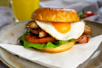 Sausage, eggs and bacon breakfast bun.