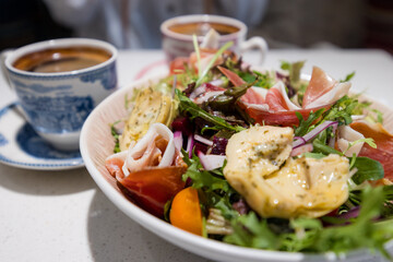 Fresh salad and hot coffee in cafe shop