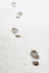 Footprints in Snow on Sidewalk Walking Away