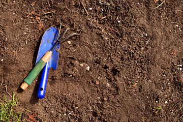 Earth from above with a blue shovel rake Top view