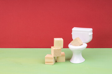 wood cubes next to a white toilet
