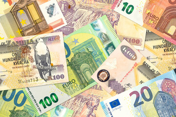 Obraz na płótnie Canvas some zambia kwacha bank notes and euro bank notes mixed indicating bilateral economic relations