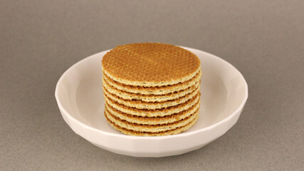 Dutch waffles in a white plate on a gray background