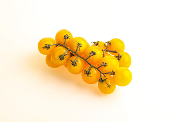 Branch with yellow cherry tomato