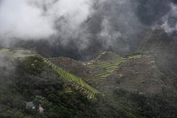 Views of Macchu Pichu through the mist and the surrounding mountains, Peru