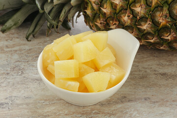 Marinated pineapple slices in the bowl