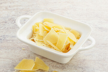 Sliced parmesan cheese heap in the bowl