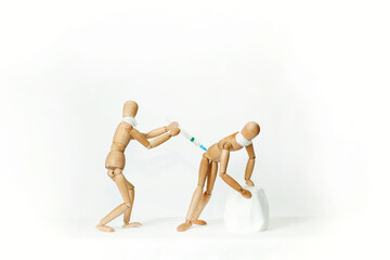 Wooden mannequins, on a white background. Vaccination.